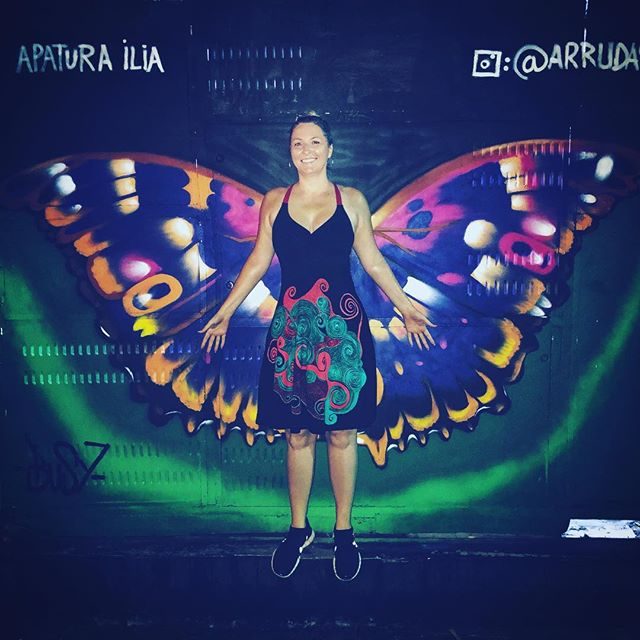 Allison in front of butterfly wing street art